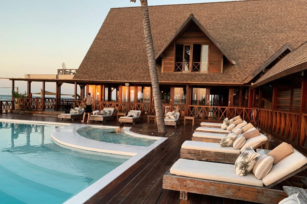exterior of a luxury resort and spa with chairs by the pool
