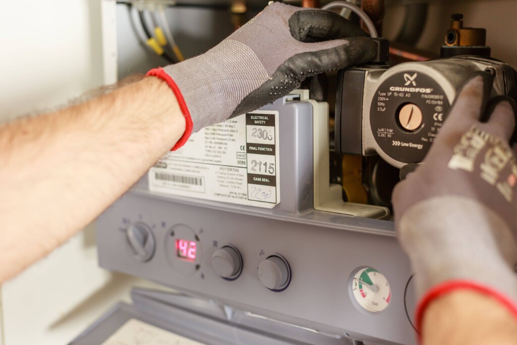 hands fixing boiler system